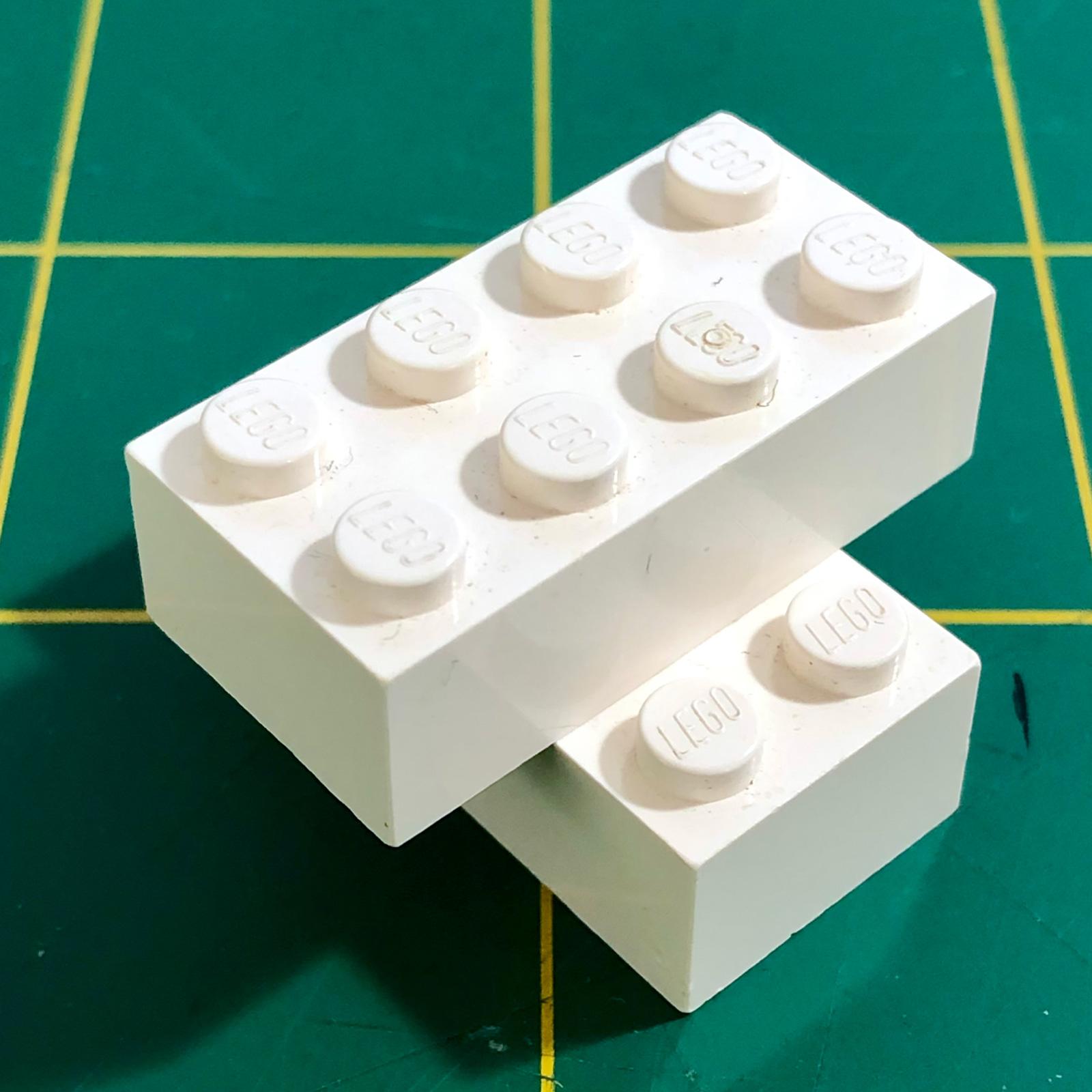 A photo of two white building bricks, in the same layout as the bricks in the previous image