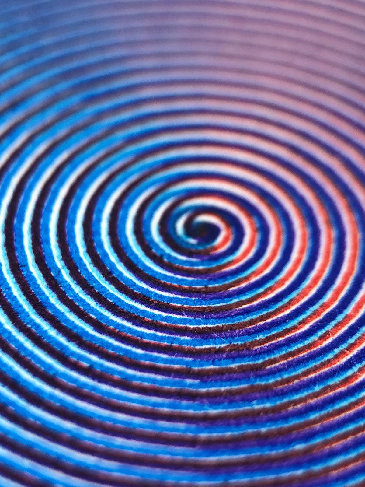 An extreme close-up of the of the center of the spiral, showing that although the overall view appears purple, it is in fact mostly made up of separate red and blue lines